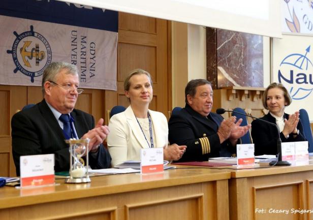 Za stołem prezydialnym, od lewej:  Prezes Nautical Institute kpt. Robert McCabe, Podsekretarz Stanu w Ministerstwie Infrastruktury prof. UG dr hab. Dorota Pyć, prorektor ds. morskich AMG dr inż. kpt. ż. w. Henryk Śniegocki prof. nadzw. AMG, kpt. ż. w. Anna Wypych Namiotko – Stały Przedstawiciel Polski przy  IMO w Londynie